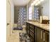Well-lit bathroom with a granite countertop vanity and blue floral rug accenting the tiled floor at 2262 Haventree Ct, Lawrenceville, GA 30043