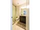 Cozy bathroom featuring tile floors, dark vanity, and a shower with a decorative green curtain at 2262 Haventree Ct, Lawrenceville, GA 30043