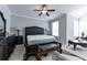 This bedroom features a ceiling fan, carpet, and large tufted headboard at 2262 Haventree Ct, Lawrenceville, GA 30043