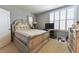 Bright bedroom with a white bed frame, plush carpeting, and a view into the adjacent bathroom at 2262 Haventree Ct, Lawrenceville, GA 30043