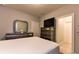 Comfortable bedroom featuring a bed, grey dresser, tv, and ample storage space at 2262 Haventree Ct, Lawrenceville, GA 30043