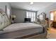 Bright bedroom with a white bed frame, plush carpeting, and a view into the adjacent bathroom at 2262 Haventree Ct, Lawrenceville, GA 30043