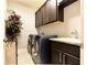 Laundry room with front-load washer/dryer, upper cabinets, and utility sink at 2262 Haventree Ct, Lawrenceville, GA 30043