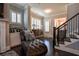 Inviting living room with a comfortable chaise lounge and staircase access at 2262 Haventree Ct, Lawrenceville, GA 30043