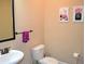Cozy bathroom with a toilet, sink, mirror, and artwork at 1032 Willow Field Se Ln # 17, Marietta, GA 30067