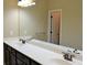Bathroom featuring dual sinks, vanity, and large mirror at 1032 Willow Field Se Ln # 17, Marietta, GA 30067
