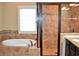 Bathroom features tile shower, tub, and granite counters at 1032 Willow Field Se Ln # 17, Marietta, GA 30067