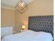 This bedroom features a gray tufted headboard and decorative light fixture at 1032 Willow Field Se Ln # 17, Marietta, GA 30067