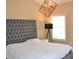 Bedroom featuring large tufted headboard and modern lighting fixture at 1032 Willow Field Se Ln # 17, Marietta, GA 30067