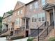 A row of townhouses features a staircase leading to the front doors at 1032 Willow Field Se Ln # 17, Marietta, GA 30067