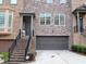 Stylish townhome featuring a stone facade, attached garage, and inviting front entrance with landscaped details at 1032 Willow Field Se Ln # 17, Marietta, GA 30067