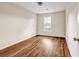Neutral bedroom featuring vinyl floors and a single window at 1600 Dillwood Ct, Lithonia, GA 30058