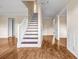 Inviting entryway with hardwood floors, staircase, chandelier, and neutral tones at 1600 Dillwood Ct, Lithonia, GA 30058