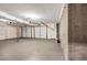 A large three car garage featuring concrete floors and drywall at 1600 Dillwood Ct, Lithonia, GA 30058