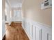 Hallway featuring dark hardwood floors and decorative white wainscotting at 1600 Dillwood Ct, Lithonia, GA 30058