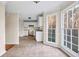 Well-lit kitchen with white cabinets, tile flooring, and windows offering natural light at 1600 Dillwood Ct, Lithonia, GA 30058