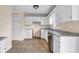 Functional kitchen with white cabinets, tile floors, and stainless steel appliances at 1600 Dillwood Ct, Lithonia, GA 30058