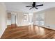 Spacious living room with hardwood floors, ceiling fan, and natural light from French doors at 1600 Dillwood Ct, Lithonia, GA 30058