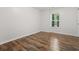 Bedroom with wood-look floors and a window at 2660 Brentwood Estates Ct, Cumming, GA 30041