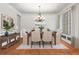 Bright dining area with a modern chandelier, a wooden table, and large windows with natural light at 2660 Brentwood Estates Ct, Cumming, GA 30041