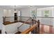Upstairs landing featuring hardwood floors, wooden railing, and views of other rooms at 2660 Brentwood Estates Ct, Cumming, GA 30041