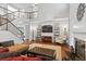 Spacious living room with a fireplace, hardwood floors, and access to a second-story balcony at 2660 Brentwood Estates Ct, Cumming, GA 30041