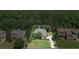 Aerial view of a two-story brick house with a well-manicured lawn surrounded by mature trees and greenery at , Cumming, GA 30041