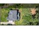 Aerial view of a home with a patio, lush green yard and a spacious lot at , Cumming, GA 30041