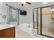 Bright bathroom features a soaking tub, tiled shower with glass door, and a vanity with granite countertop at , Cumming, GA 30041