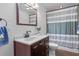 Updated half bathroom featuring a dark wood vanity, shower and toilet at , Cumming, GA 30041