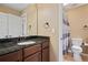 Cozy bathroom with dark granite counters and stainless steel faucet fixtures, with a tiled shower and vanity at , Cumming, GA 30041