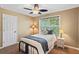 Cozy bedroom with a ceiling fan and a well-lit window for natural light, and a small bedside table at , Cumming, GA 30041