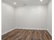 Empty bonus room space with laminate wood flooring and neutral color palette at , Cumming, GA 30041