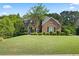 Well-manicured lawn and landscaping enhance this two-story brick home's curb appeal at , Cumming, GA 30041