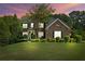 Well-manicured lawn and landscaping enhance this two-story brick home at dusk at , Cumming, GA 30041