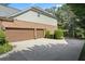 Spacious two-car garage with concrete driveway and partial brick facade at , Cumming, GA 30041