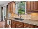 The kitchen boasts granite countertops, wood cabinets, and stainless steel appliances beneath a window at , Cumming, GA 30041
