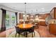 Eat-in kitchen featuring custom cabinetry, granite counters, stainless appliances, and access to the patio at , Cumming, GA 30041