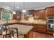 Well-equipped kitchen featuring granite counters, wood cabinets, and stainless appliances at , Cumming, GA 30041