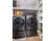Modern laundry room with front-load washer and dryer, built-in shelving and storage for convenience at , Cumming, GA 30041