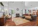 Bright living room boasts high ceilings, fireplace, hardwood floors, and an open concept design at , Cumming, GA 30041