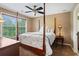 The main bedroom features a four-poster bed frame, large windows, and neutral color palette at , Cumming, GA 30041