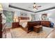 Bright primary bedroom featuring a trey ceiling, hardwood floors, a decorative rug, and ample dresser storage at , Cumming, GA 30041