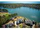 Aerial view of a stunning lakeside estate with manicured lawns, a sparkling pool, and mature trees surrounding the property at 1160 Lake Shore Overlook, Alpharetta, GA 30005