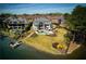 Expansive backyard featuring lush lawn, a sparkling pool, lush landscaping, and a private boat dock on the serene lake at 1160 Lake Shore Overlook, Alpharetta, GA 30005