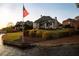 Waterfront property featuring manicured lawn, and beautiful architecture during golden hour at 1160 Lake Shore Overlook, Alpharetta, GA 30005