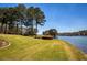 Beautiful lush green grass leading to a calm lake on a sunny day with trees in the background at 1160 Lake Shore Overlook, Alpharetta, GA 30005