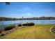 Expansive lawn leading to the lake showcasing meticulous landscaping with decorative bushes at 1160 Lake Shore Overlook, Alpharetta, GA 30005