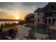 Backyard with a pool, a lake view, and a setting sun at 1160 Lake Shore Overlook, Alpharetta, GA 30005
