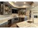 A basement bar has granite countertops, custom cabinetry, a beverage fridge, and a brick backsplash at 1160 Lake Shore Overlook, Alpharetta, GA 30005